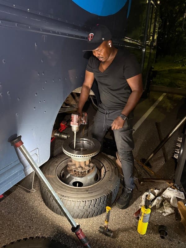 man repairs brake rotor on Amazon truck