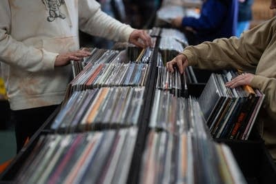 People browse records in a record store
