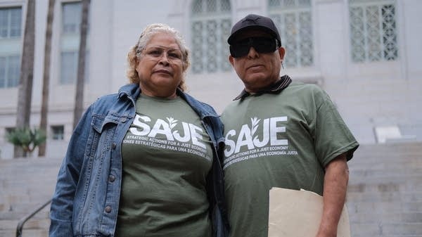 Humberto Altamira and his wife stand in front of LA City Hall ahead of a City Council vote on rent control.