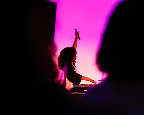 dj mcshellen on stage with a microphone in her hand