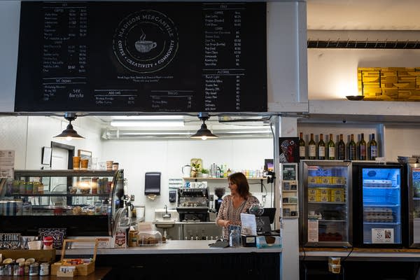 A woman works at a cafe