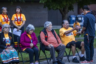 People sit in chairs