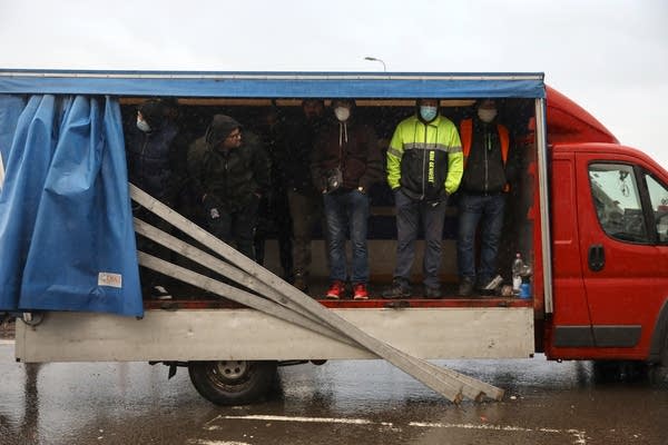 Truck drivers shelter from the rain as they wait at the Port of Dover due to a French border closure over covid-19 transmission worries. (Photo by Dan Kitwood/Getty Images)