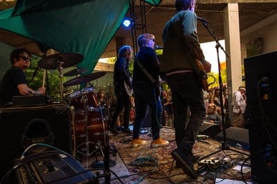a rock band performing on an outdoor stage