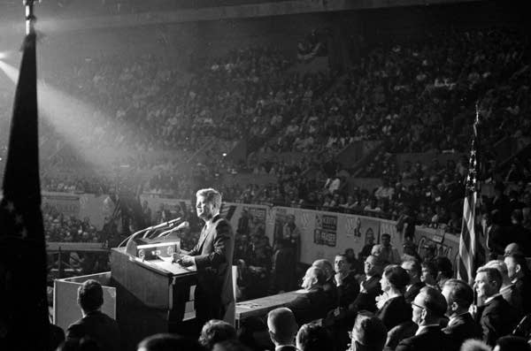 A man talks to a large crowd