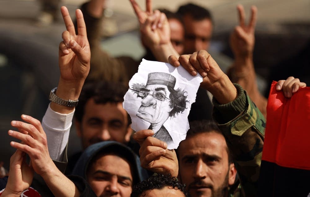 Libyan protesters flash the V for