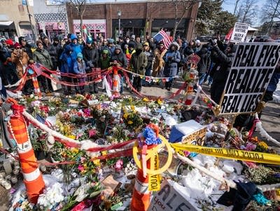 People gather at the site of Alex Pretti’s memorial