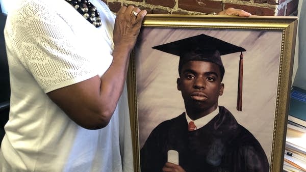 Dorothy Johnson-Speight holds a picture of her son, Khaaliq. He was fatally shot in Philadelphia in 2001 by a neighbor who was a convicted felon and should not have been able to own a gun.