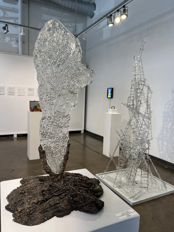Two metallica sculptures in a gallery