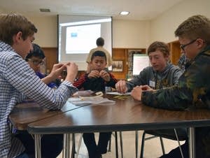 Boys build towers out of uncooked spaghetti and marshmallows.