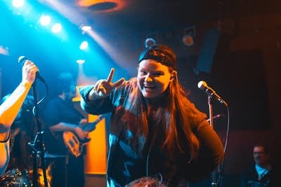 mae simpson and her band performing on stage