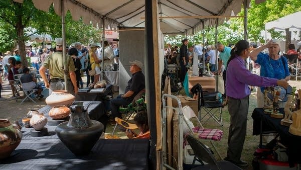 Above, people enjoy the Santa Fe Indian Market, which draws roughly 1,200 Indigenous artists and craftspeople from across North America, in 2019. 