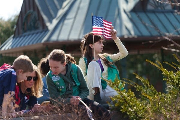 A child holds the U.S. flag