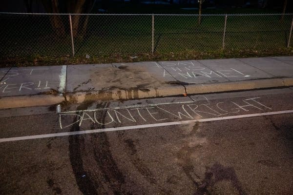 Chalk writing on the ground marks where a person was killed.