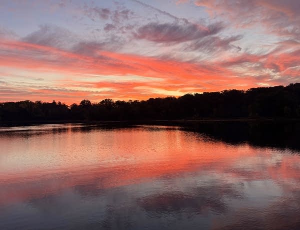 a sunrise scene on a lake