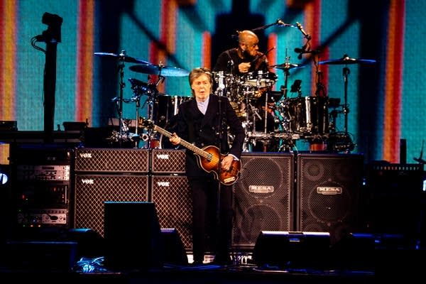 Paul McCartney performing on stage