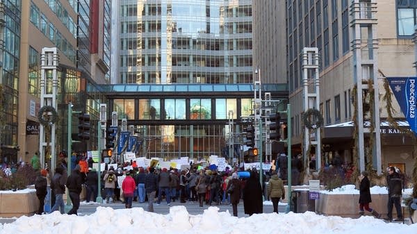 People gather to protest the immigration executive order in Rochester.