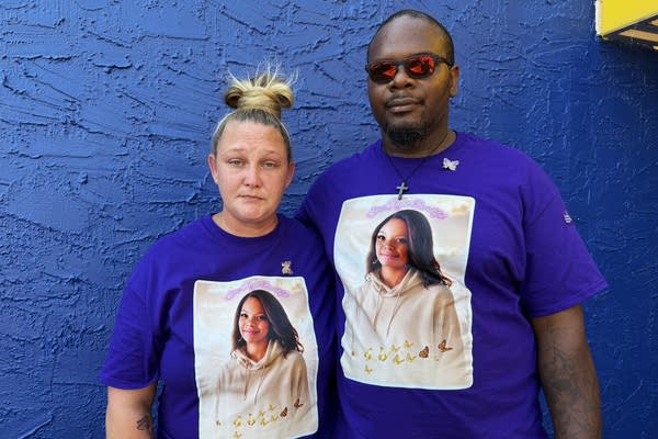 Two people wear memorial t-shirts