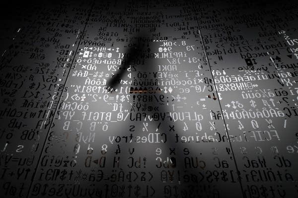 (FILES) A picture taken on October 17, 2016 shows an employee walking behind a glass wall with machine coding symbols at the headquarters of Internet security giant Kaspersky in Moscow.
The US government banned the use of Kaspersky security software in federal offices on September 13, 2017, saying the Russian company has risky ties to Russian intelligence that threaten US national security.