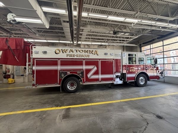 A fire truck sits inside a building.