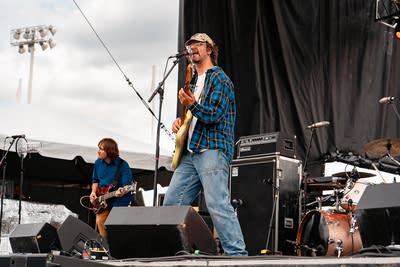the band hotline tnt performing on an outdoor stage