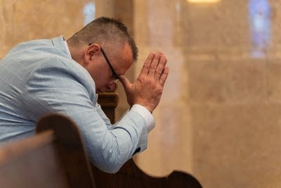 man praying in church
