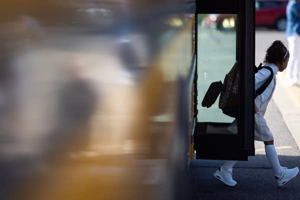 A student exits a bus