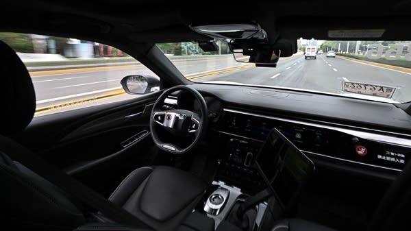 Above, an autonomous vehicle in Wuhan in August 2024.
