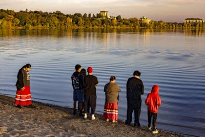 People stand along a shore