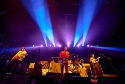 Four musicians performing together onstage
