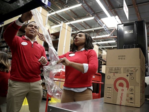 Employees demonstrate air pillow machines at a Target store
