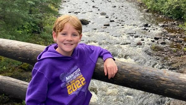 A boy poses for a photo