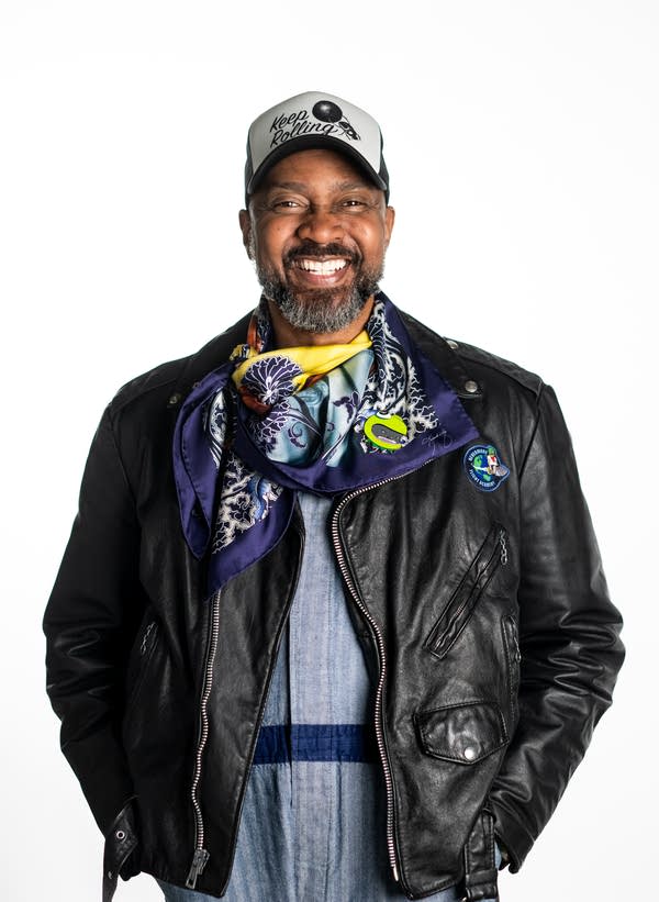 A man wearing a hat and jacket smiles for photo