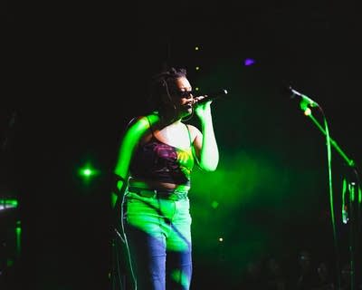 A musician sings and gestures during on onstage performance