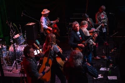 A group of musicians perform onstage.