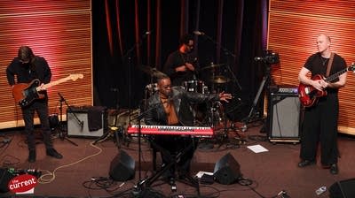 A band performing in a small auditorium