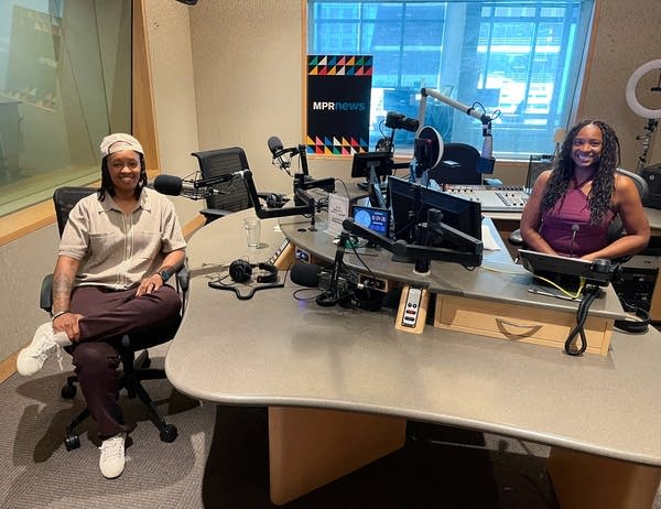 two women smiling in a broadcast studio
