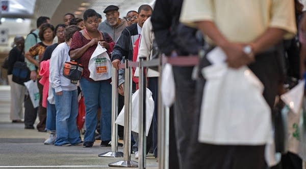 People seeking employment line up outside an employment guide job fair on September 17, 2009 at the Baltimore Convention Center in Baltimore, Maryland.