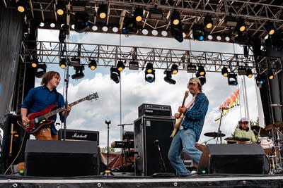 the band hotline tnt performing on an outdoor stage