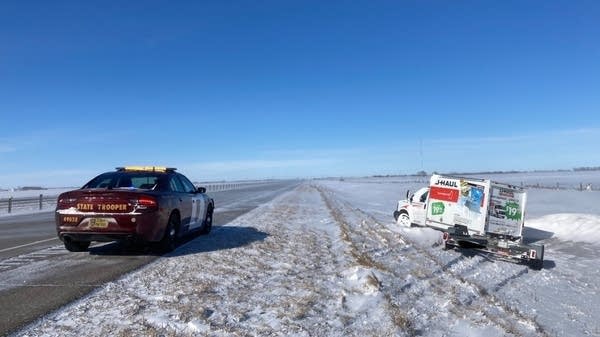 A state trooper responds to a truck off the road