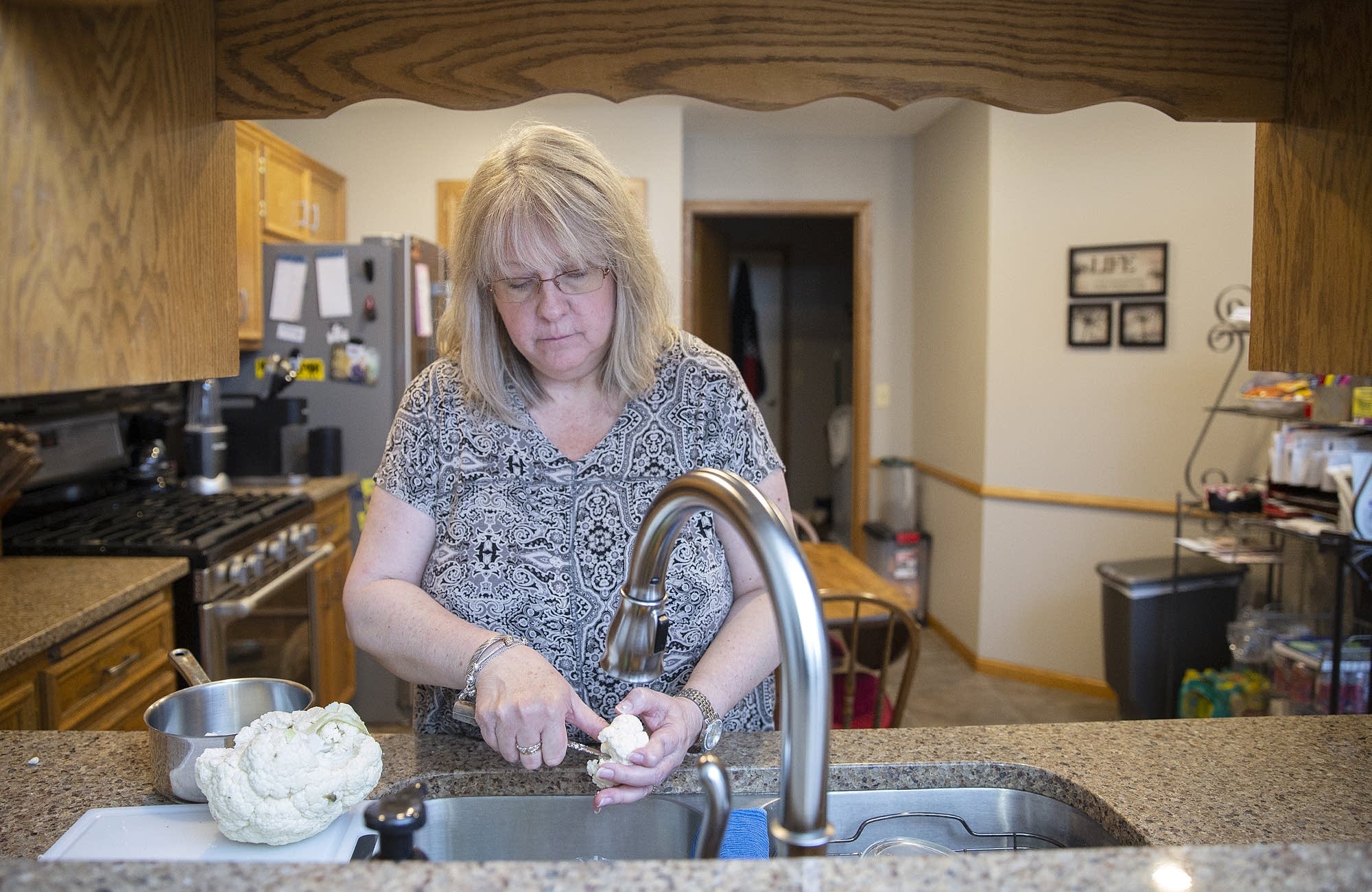 Lynn Cordova makes dinner at her single-level townhome in Apple Valley.
