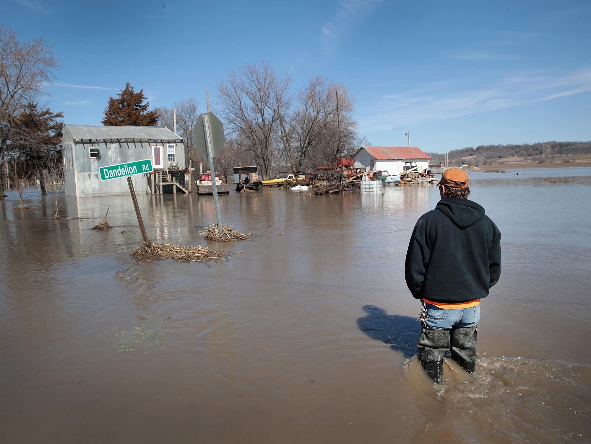 Brian Nutchler walks through floodwaters to his home