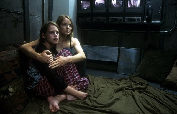 Kristen Stewart is held by Jodie Foster in a scene from the film 'Panic Room', 2002. (Photo by Columbia Pictures /Getty Images)