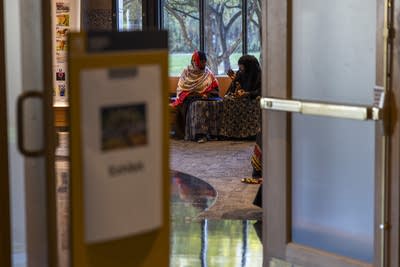 two people sitting and talking