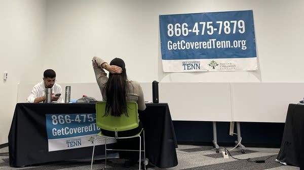 ACA marketplace navigators meet with people who need to buy coverage on their own at an event in 2022 in Nashville.