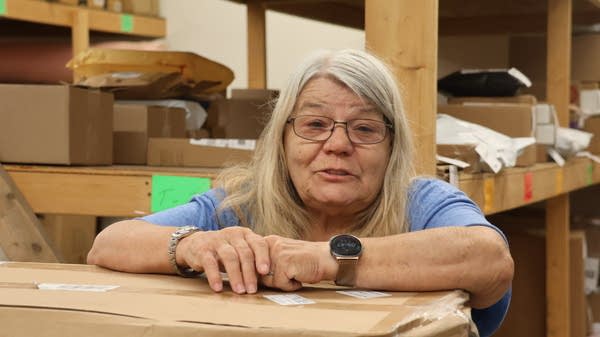 Woman leaning on box