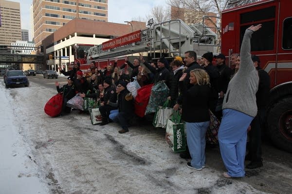 Volunteers waving by fire truck