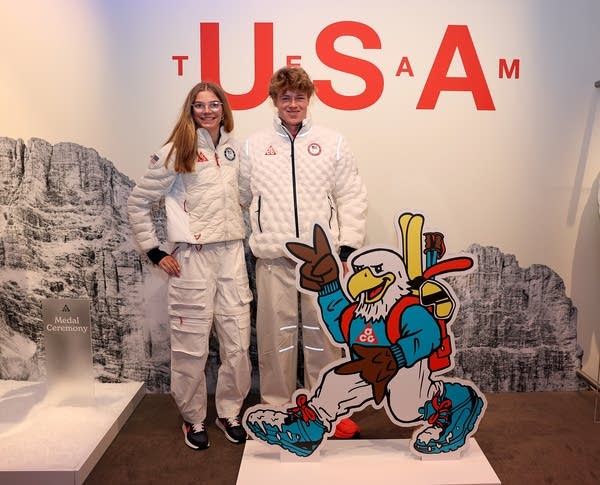 Two athletes pose for a photo.