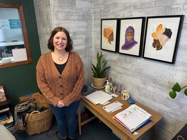 woman posing for photo by her desk