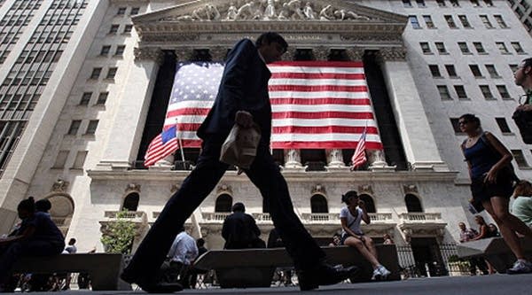 People walk past the New York Stock Exchange during afternoon trading on Aug. 4, 2011 in New York City.